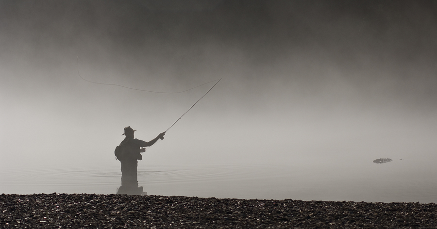 A fly fisherman casts toward trout in the White River, Arkansas.