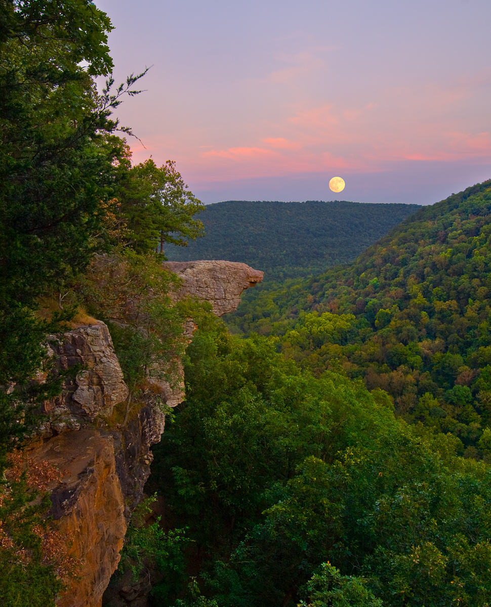 A full moon rises through thin clouds at sunset - Hawksbill Crag.