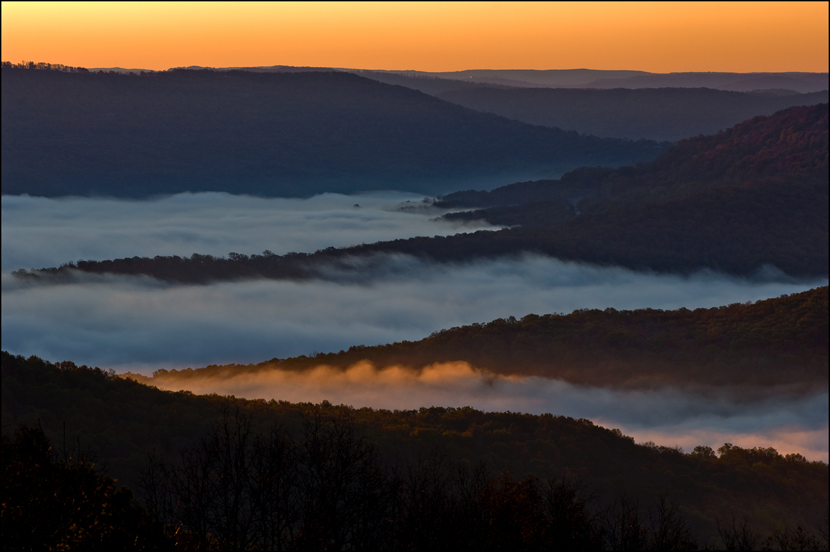 First morning light grazes the top of a layer of fog in Boxley Valley.